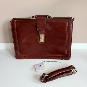 Mancini Luxurious Litigator brown leather briefcase with strap and key.